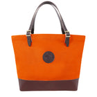 Deluxe Market Tote in hunter’s orange with dark leather handles and base, crafted by Duluth Pack for rugged outdoor use and durable everyday carrying.