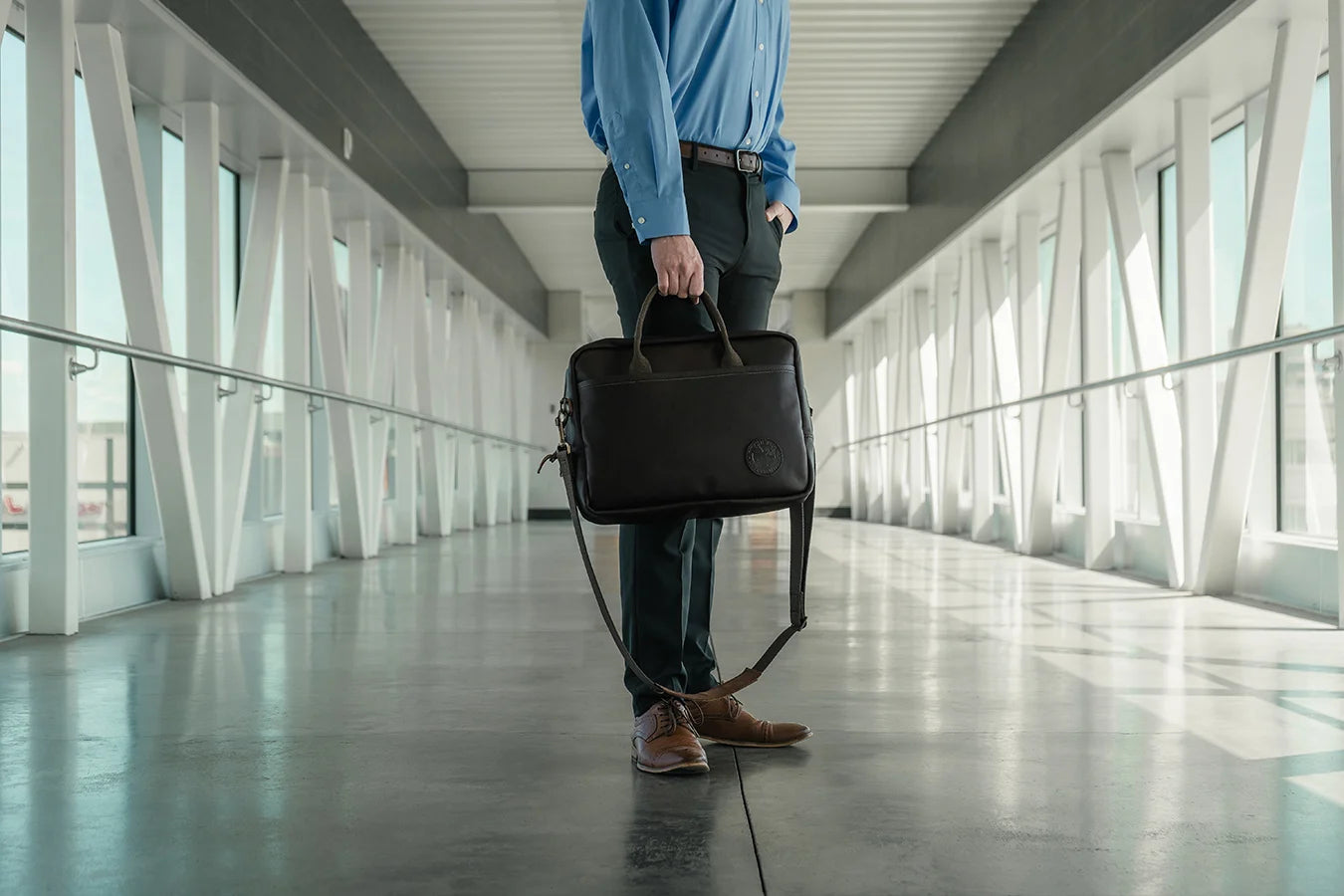 The Innovator Briefcase being carried by a man in a hallway