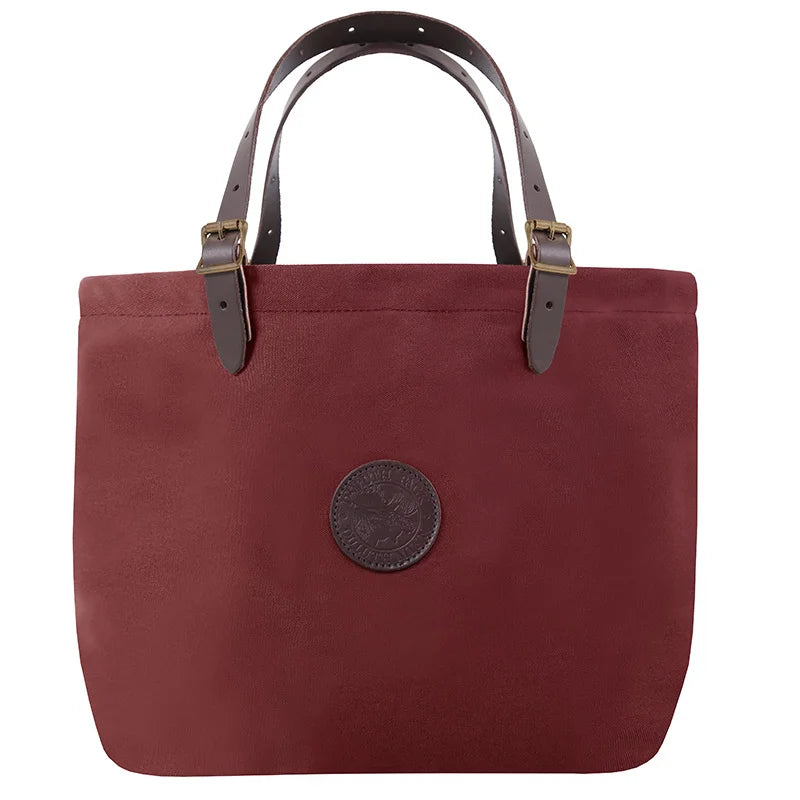 Market Tote in Burgundy with adjustable premium leather handles and antique brass hardware, designed for rugged outdoor use and lasting durability by Duluth Pack.