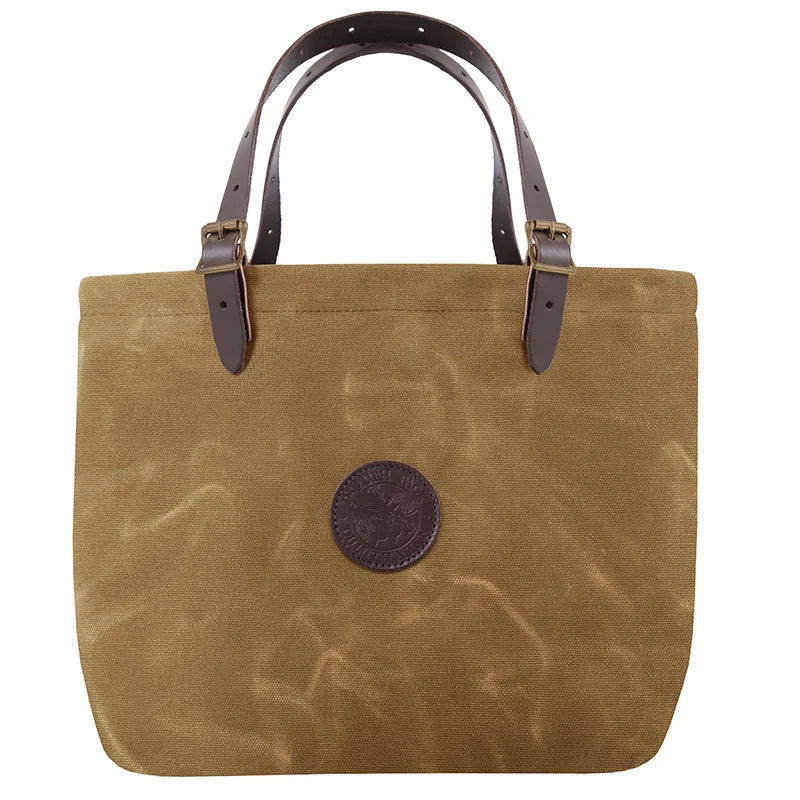 Market Tote in waxed khaki canvas with adjustable leather handles and antique brass hardware, handcrafted by Duluth Pack for rugged outdoor use.