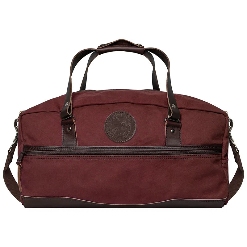 Weekender Duffel in Burgundy with handcrafted leather accents by Duluth Pack, designed for rugged outdoor use and lasting travel durability.