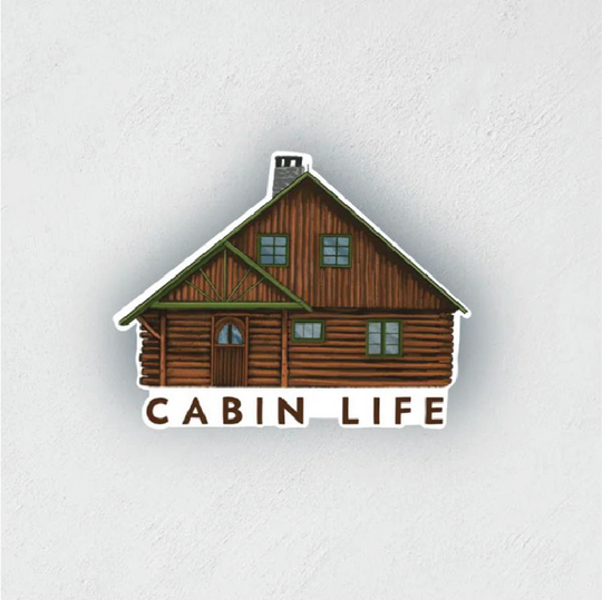 Sticker of a log cabin that says "cabin life" at the bottom.