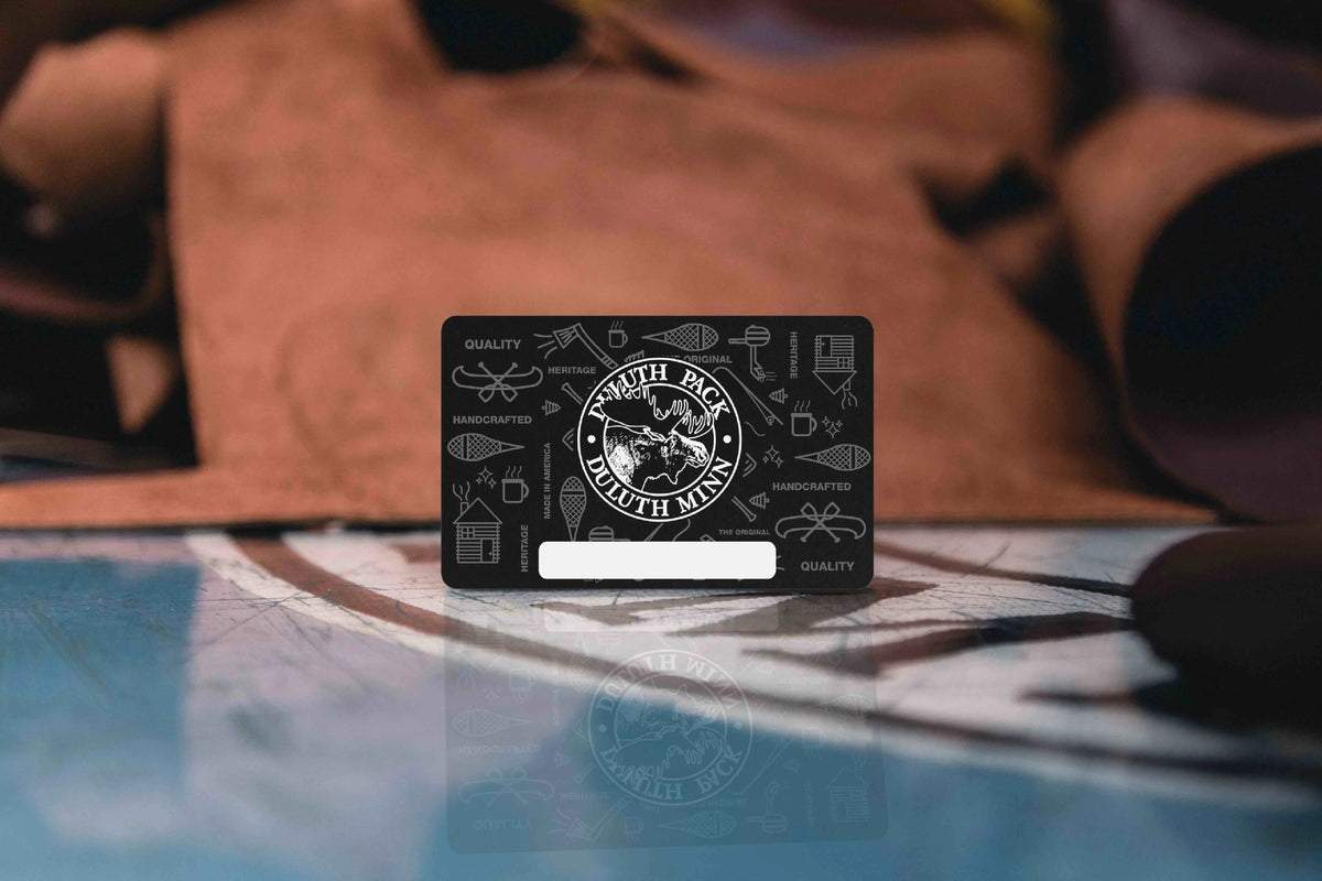 Duluth Pack E-Gift Card with full grain leather in the background