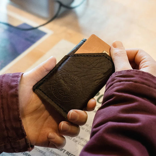 Bison Leather Card Sleeve being held by hands withdrawing card
